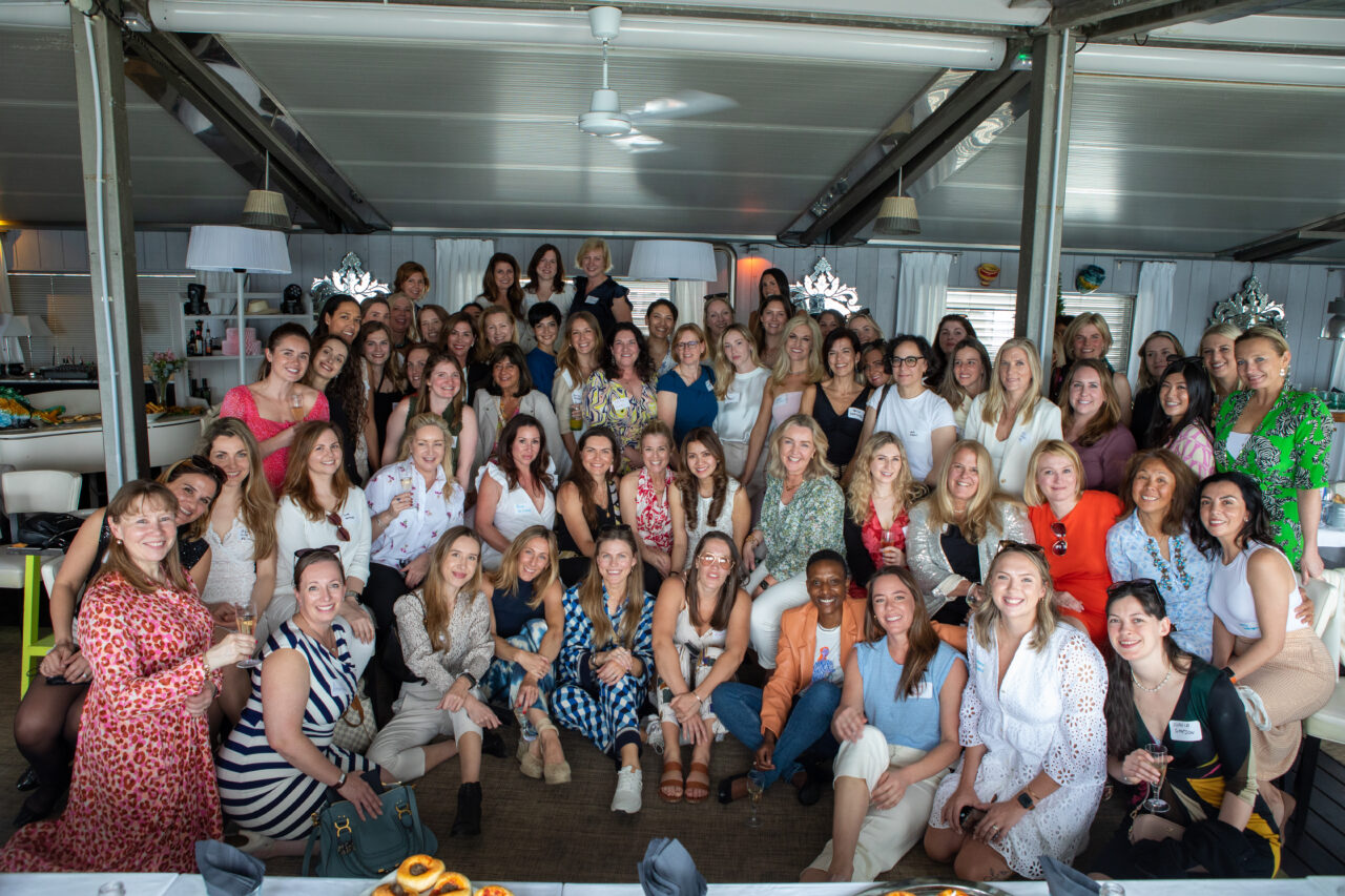 A group photo of 60 women smiling