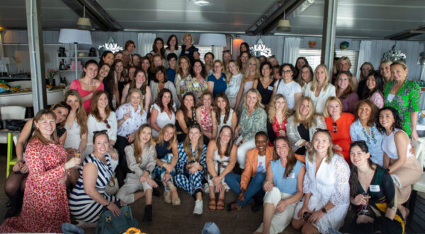 A group photo of 60 women smiling